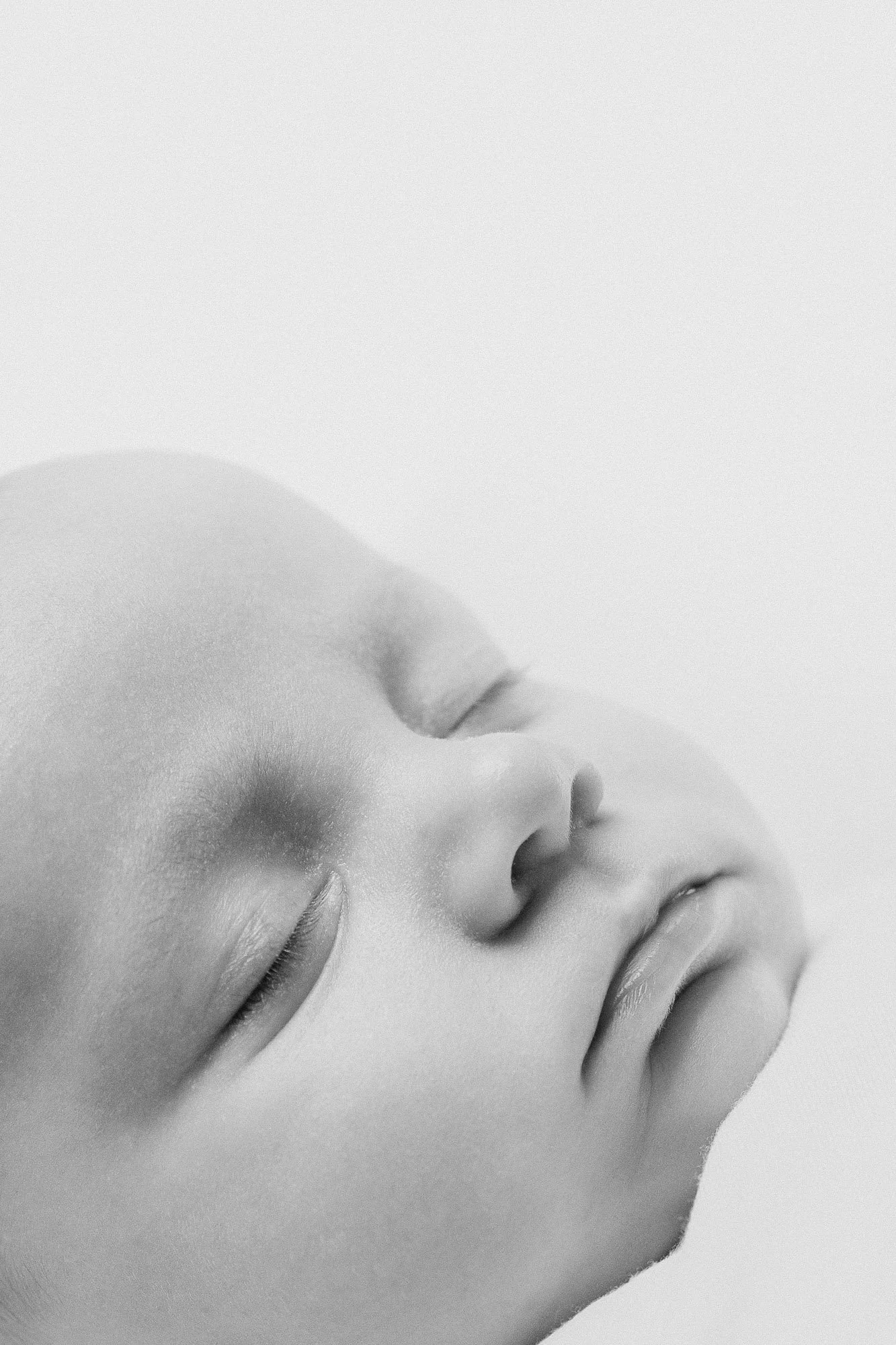 black and white newborn portrait with closeup detail of baby's face during a lifestyle newborn session in Hinsdale