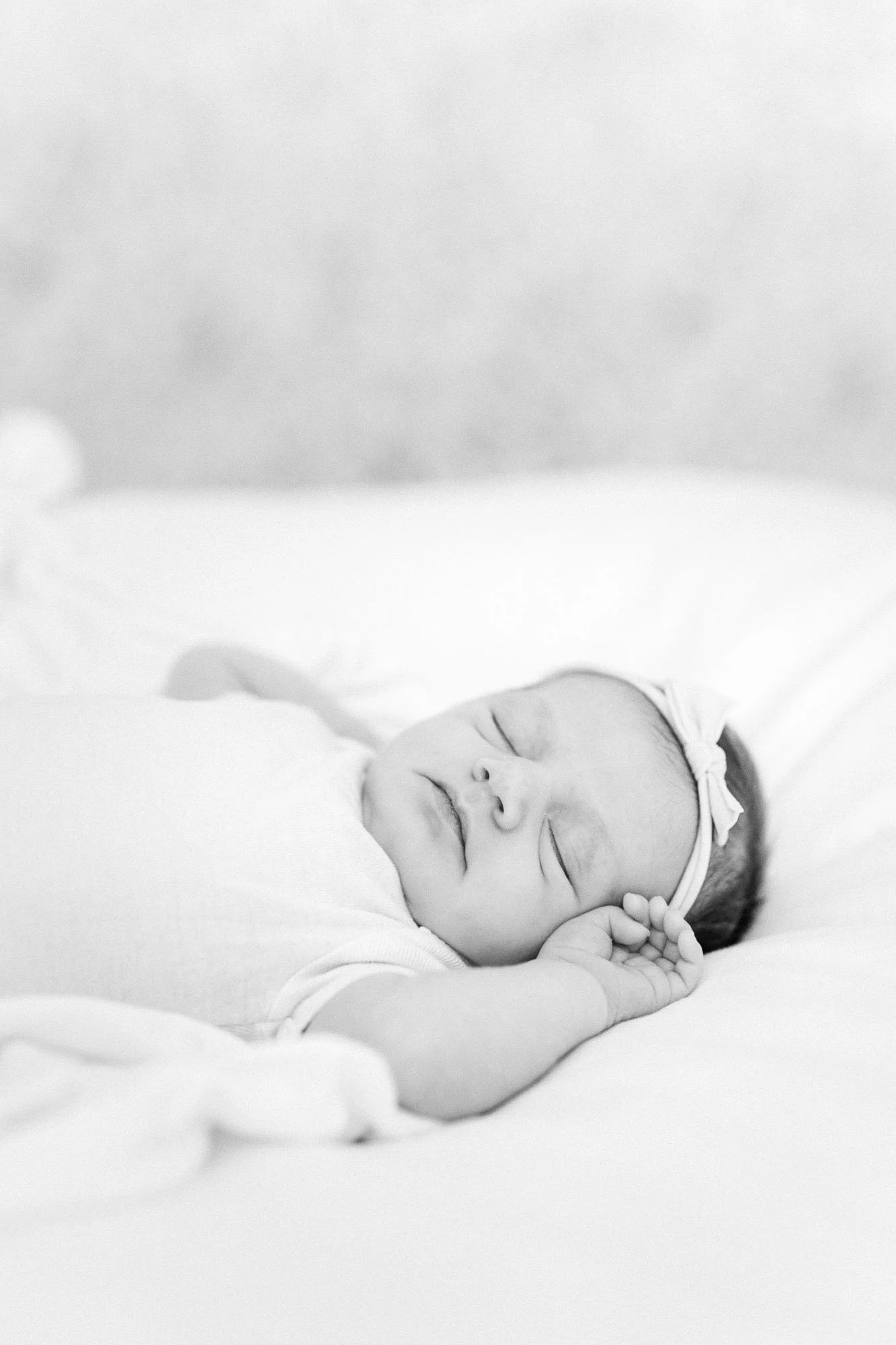 newborn baby lying naturally on bed