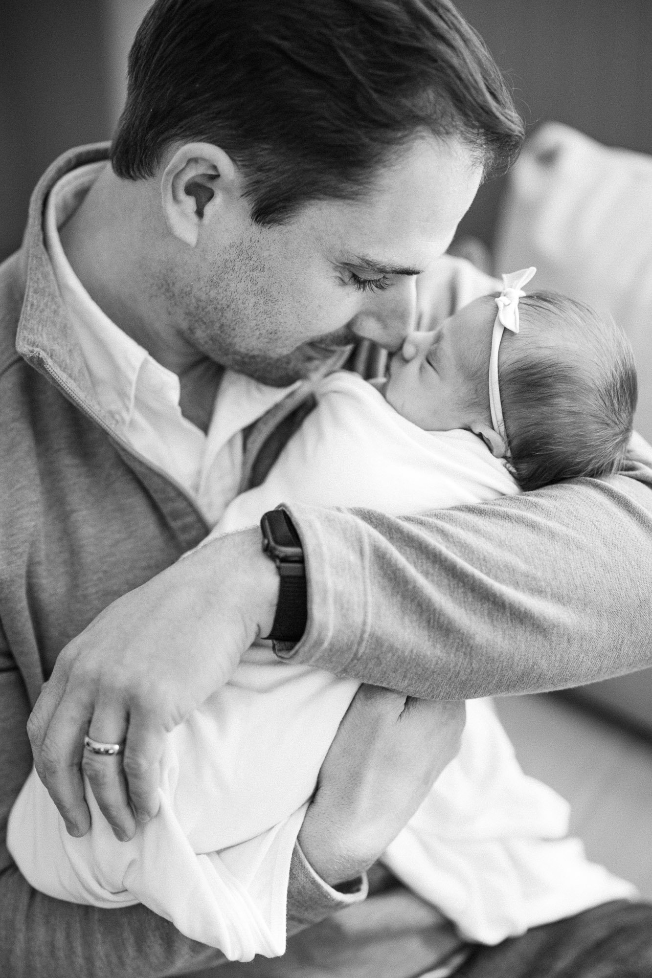 black and white photo of a dad holding his baby girl during a home newborn session in Arlington Heights by Christi Lynn Photography