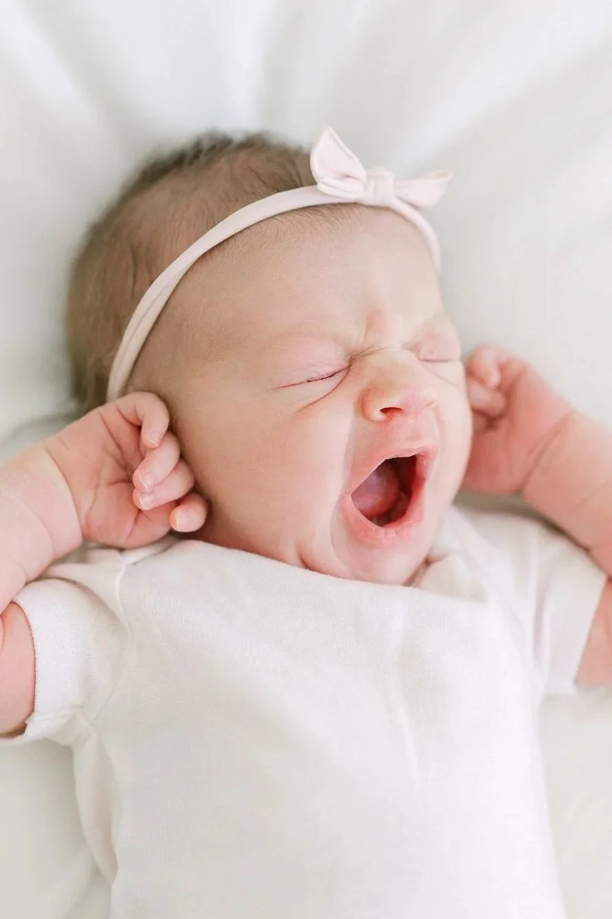 newborn baby girl yawning during an Arlington Heights newborn photography session