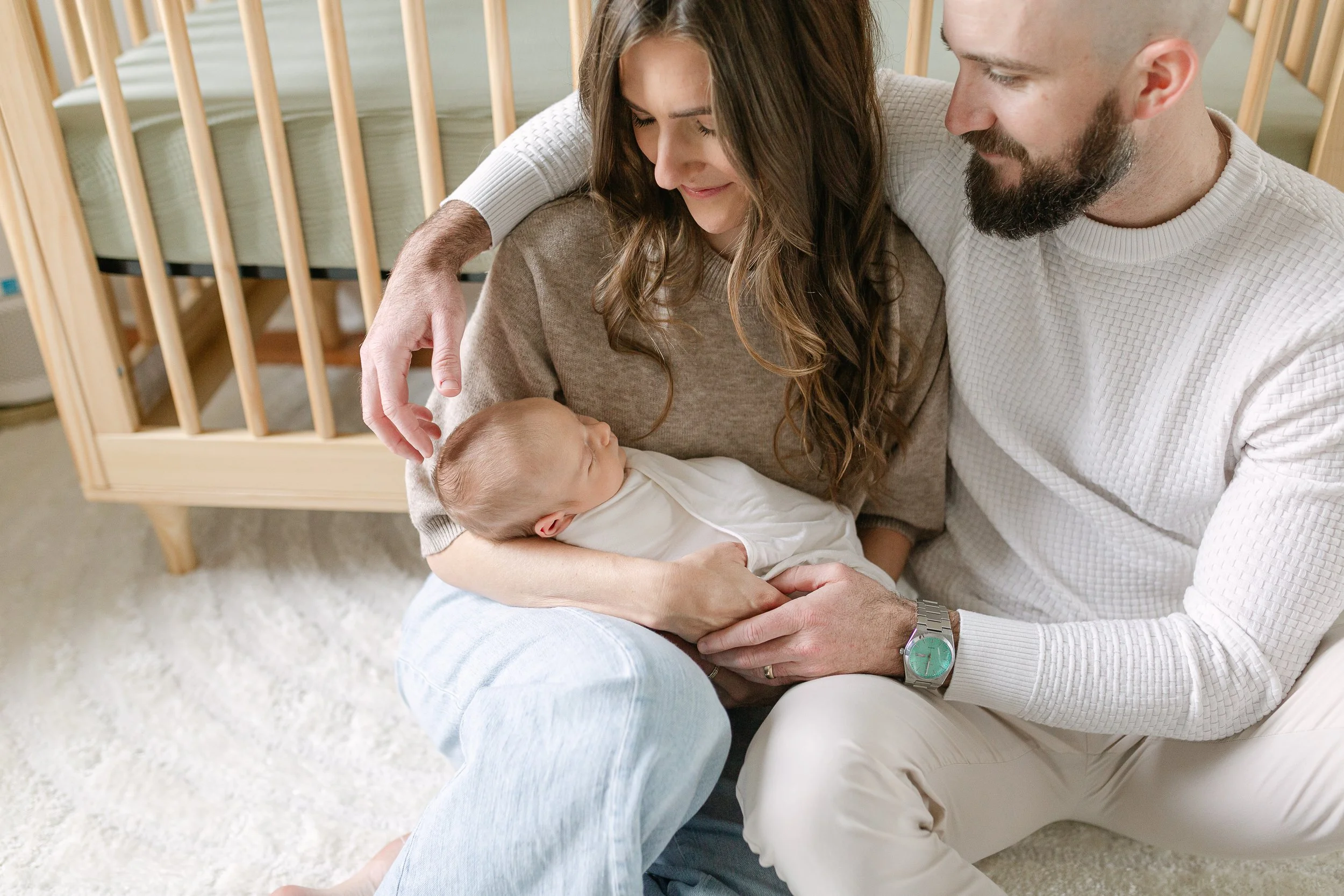 mom and dad holding their newborn baby during a Chicago newborn session at home