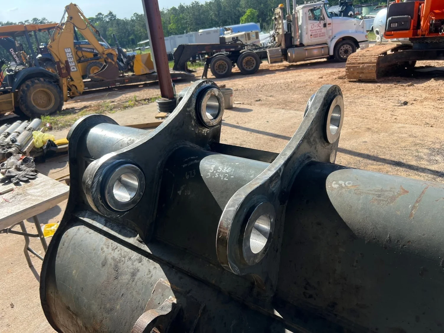 Heavy equipment attachment showing pivot and mounting components
