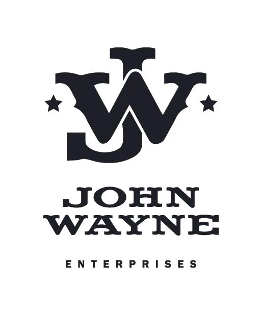 A black and white logo with a stylized letter W, two stars on each side, and the text 'John Wayne Enterprises' below.