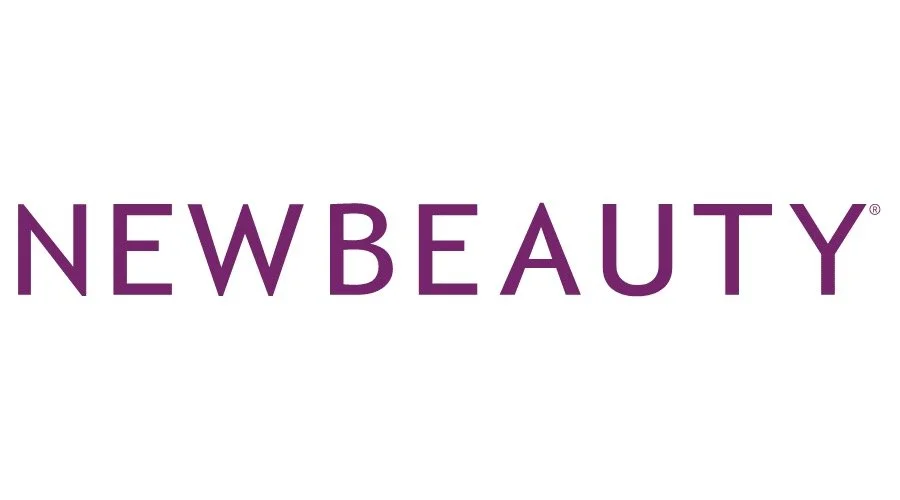 The logo of NEWBEAUTY written in purple capital letters on a white background.