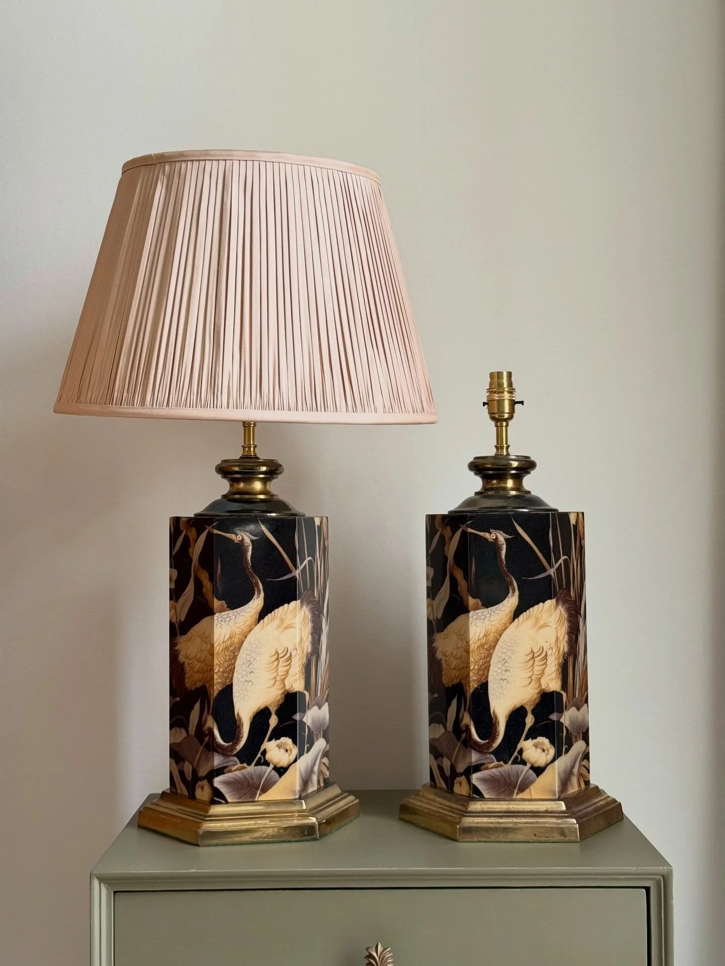 The crane pair.

Elegant decorative lamps featuring graceful cranes among lotus leaves on a dark ground.
They bring a warm glow and a touch of theatrical charm to a room.

Perfect as bedside lamps or a striking symmetrical pair on a console. Price an