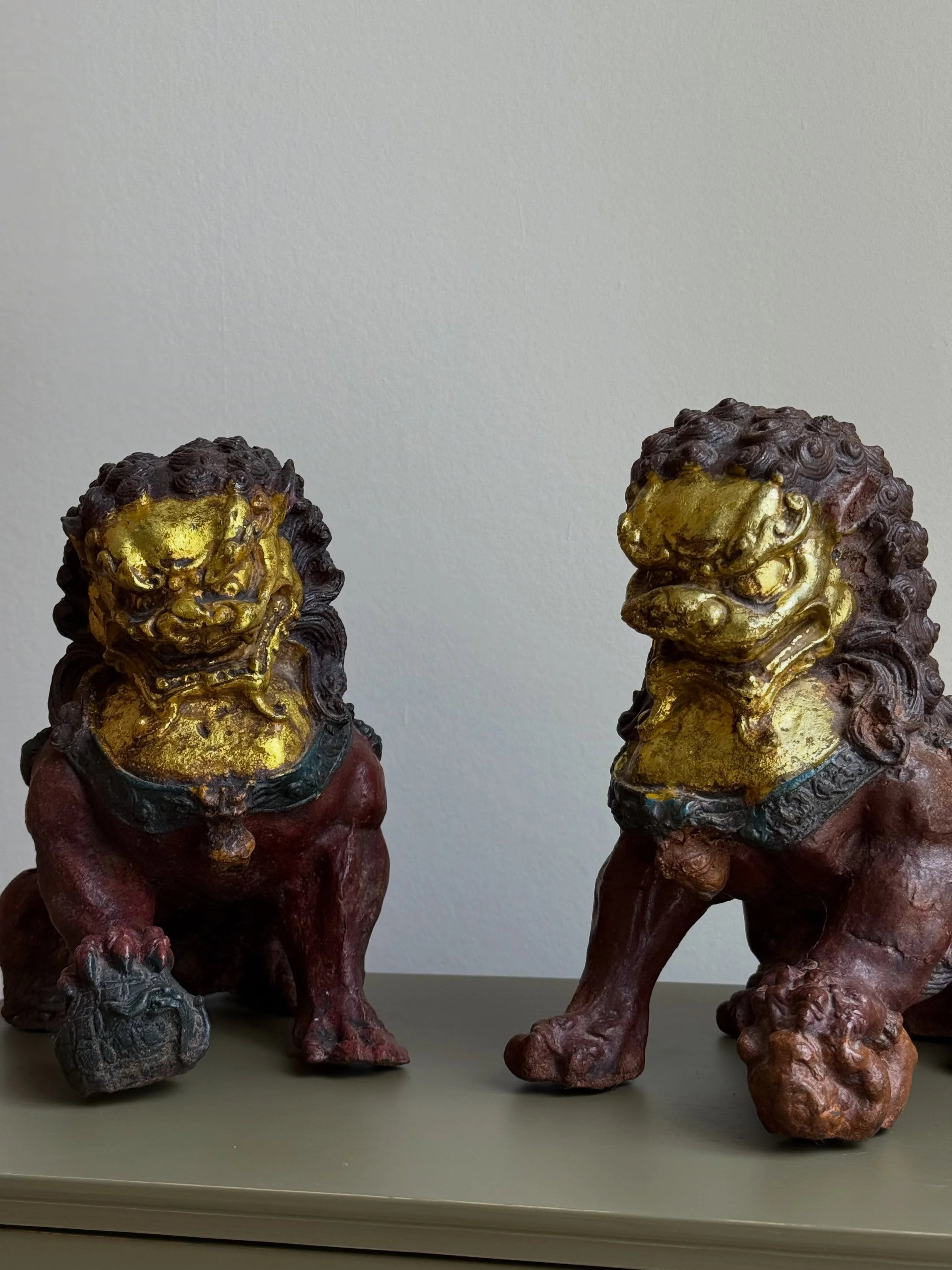 A pair of cast iron temple lions with worn gilded detail and a wonderfully fierce expression. Heavy enough that once they&rsquo;re in place, they stay there.
Collection from Pimlico strongly advised unless you enjoy carrying 12 kilos of bad decisions