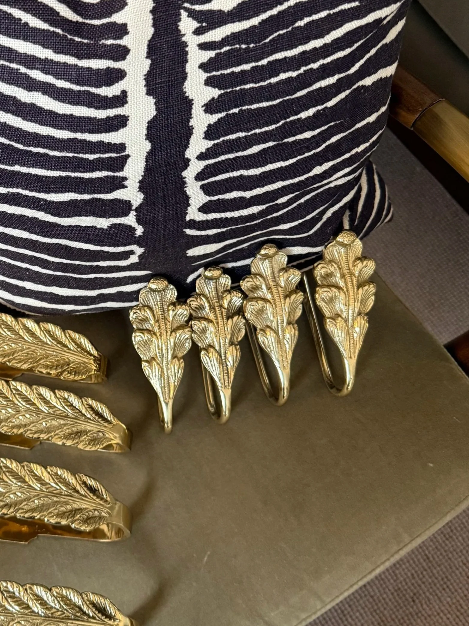 A Pair Of Small Brass Curtain Hooks