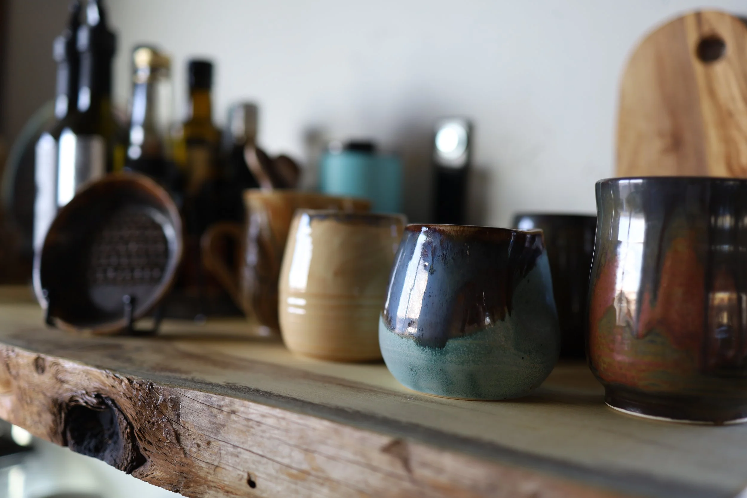 Hand Crafted mugs on wooden shelf