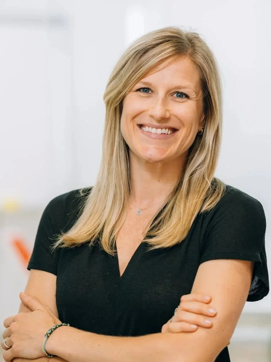 A woman with beautiful, long, blonde hair and a gorgeous smile.