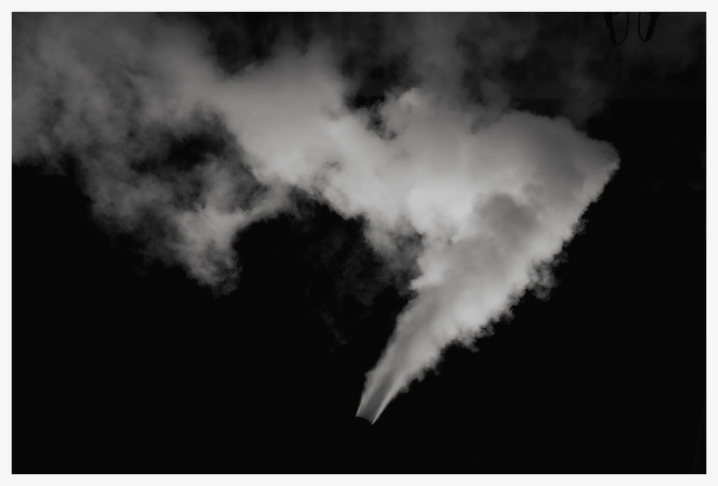 A dark night sky with a bright, dense steam or smoke plume rising from a source below the frame, creating billowing clouds.