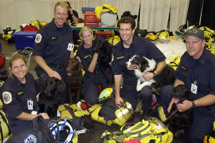  FEMA 3975 - FEMA Urban Search and Rescue team, from left to right, D. Tosch, H. Orr, K. Gordon, R. Weckbacher and M. Scott, pose for a portrait with their dogs. Photo by Michael Rieger/ FEMA News Photo. 