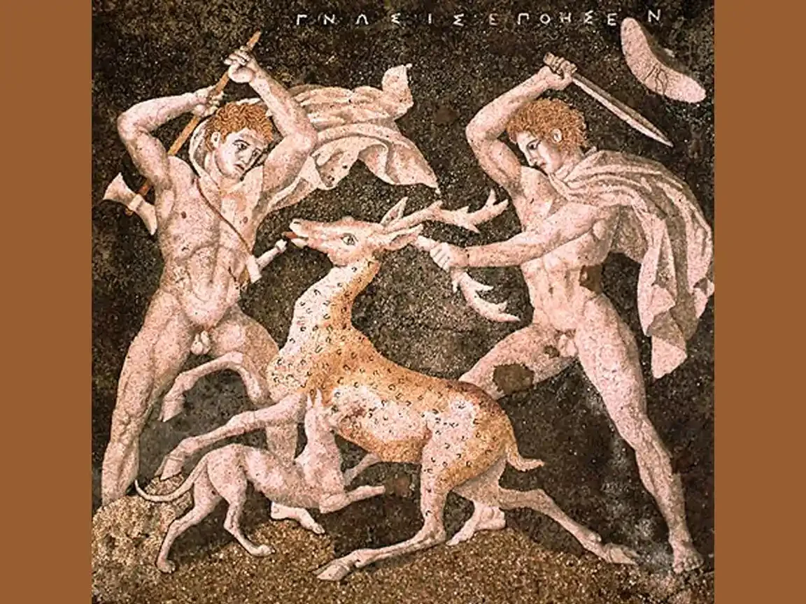 Ancient Greek pebble mosaic showing two hunters killing a stag, with a lean hound at their feet. Pella, c. 300 BC.
