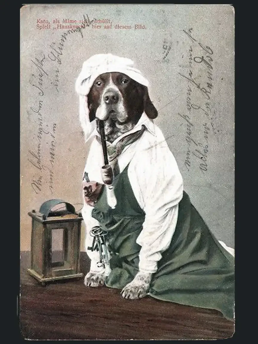Dog dressed as a chef in a vintage postcard, wearing an apron and headscarf, holding a pipe beside a small lantern, posed like a human worker.