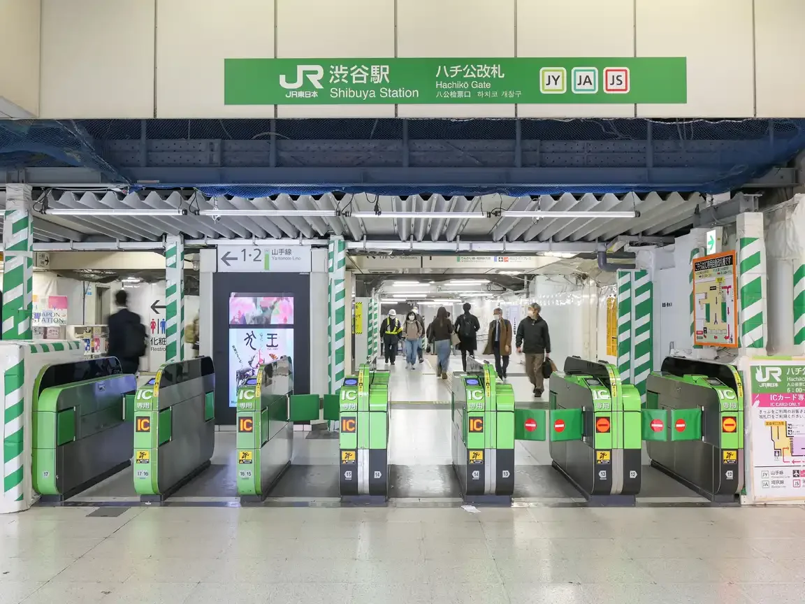 Entrance to Shibuya Station showing the “Hachikō Gate” sign above the ticket barriers.