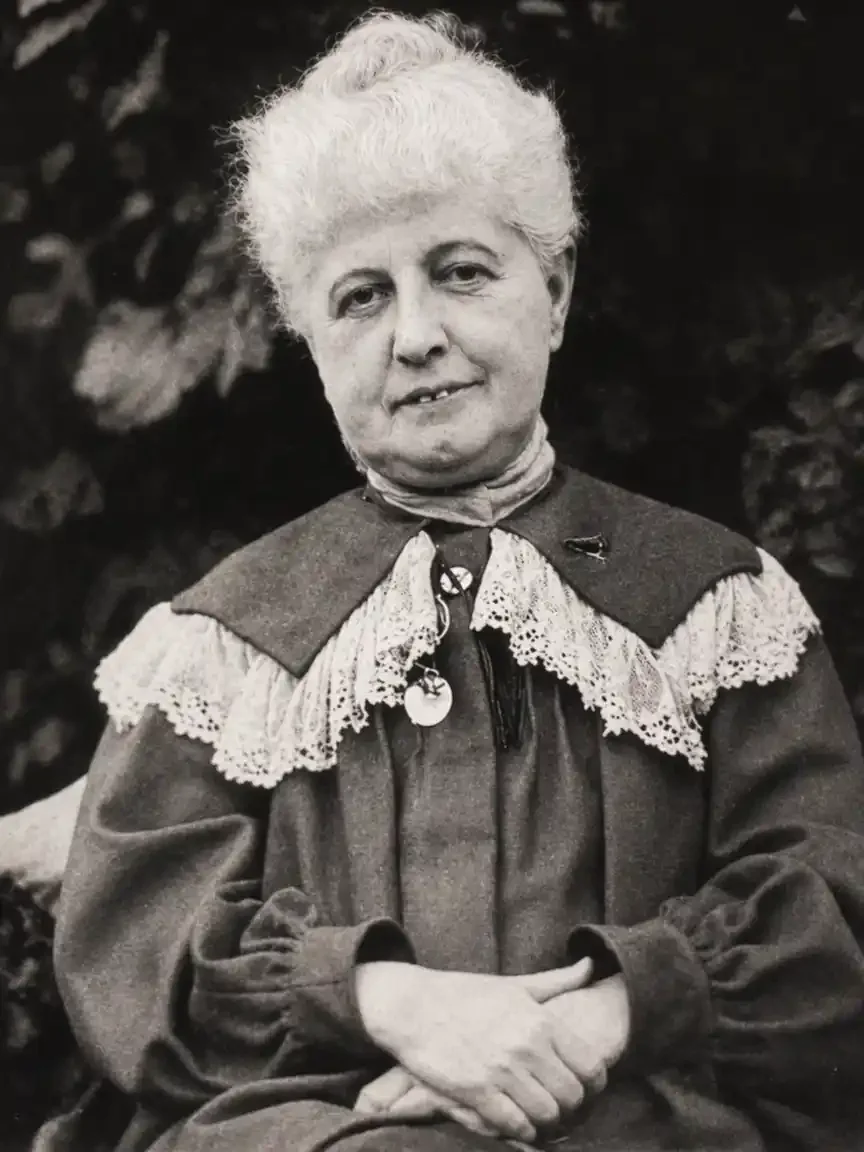 Black-and-white portrait photograph of Marie Trevelyan, a Victorian woman with white hair, seated with hands folded, wearing a dark dress with lace collar.