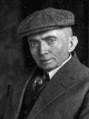 Black-and-white portrait of artist Cassius Marcellus Coolidge wearing a flat cap and suit, looking toward the camera.