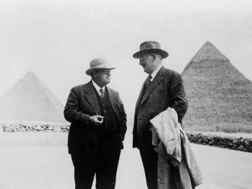 Egyptologist George Reisner standing near the pyramids of Giza during an early archaeological expedition.