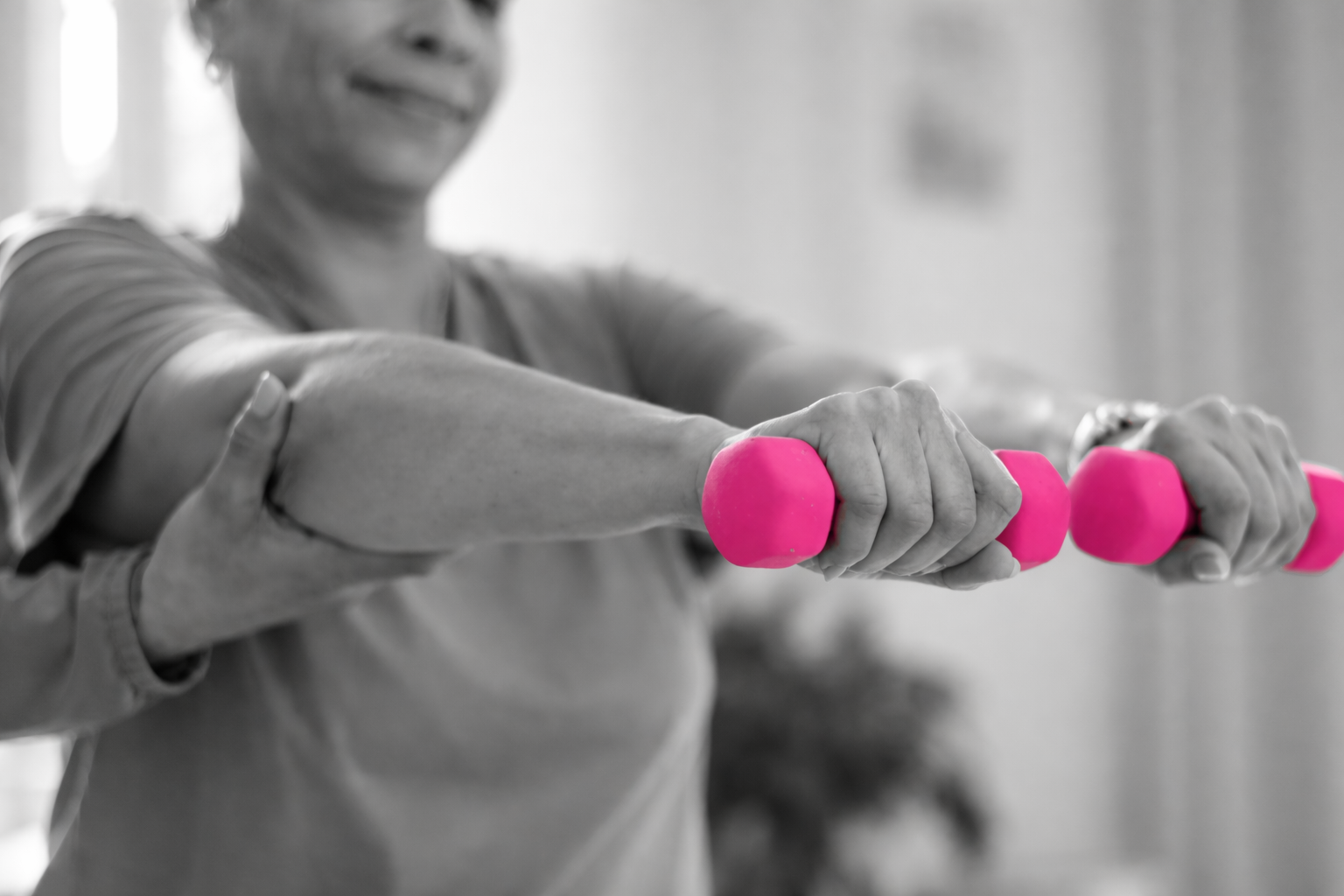 Woman receiving breast cancer rehabilitation therapy in NYC clinic