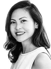 A portrait of a smiling woman with shoulder-length dark hair, wearing a sleeveless top.