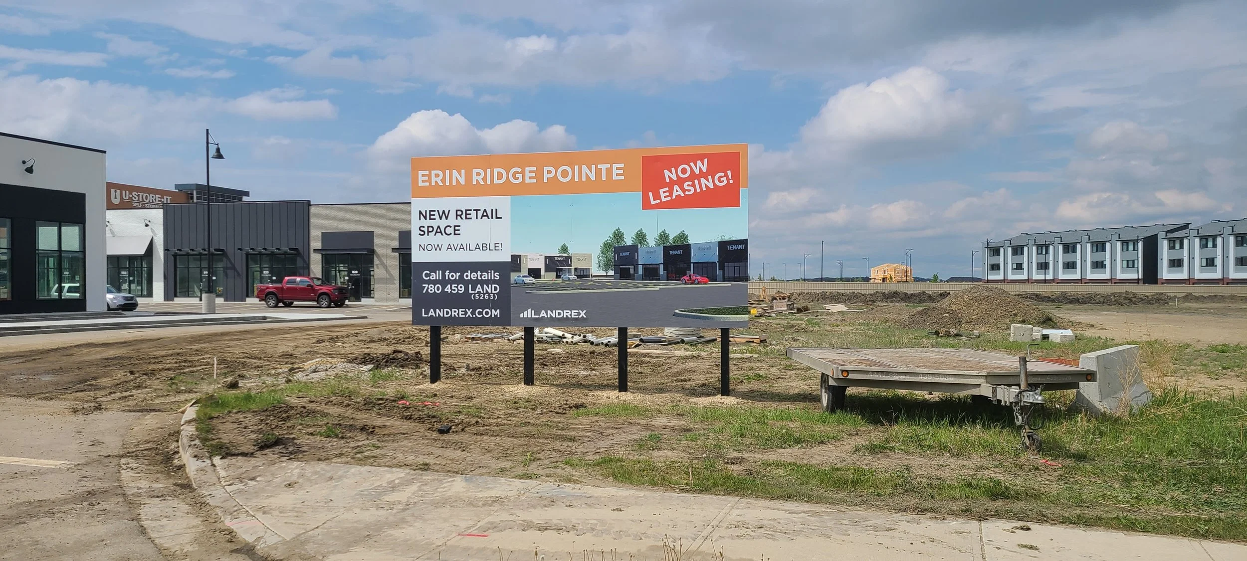 Billboard advertising new retail space leasing at Erin Ridge Pointe with a website and phone number