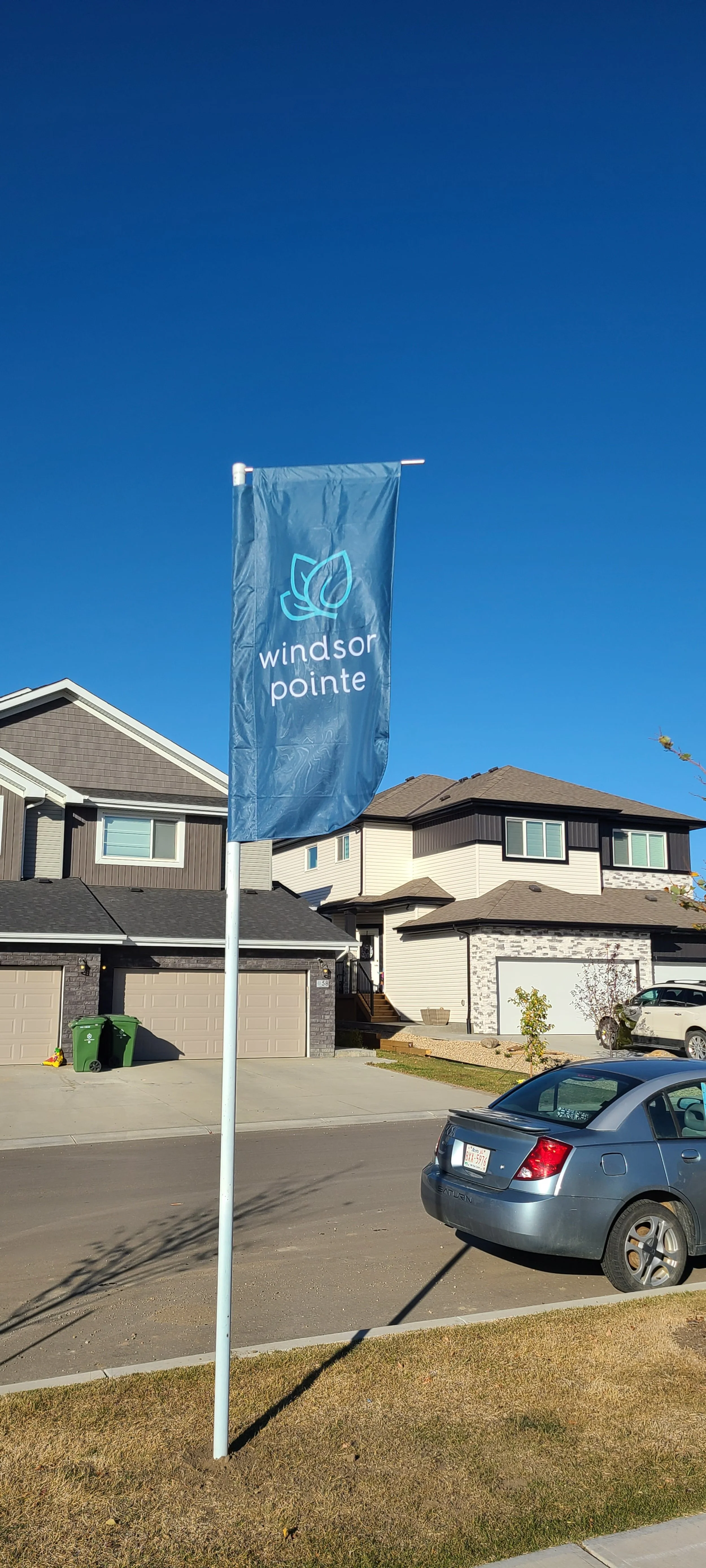 A blue flag with a leaf logo and the words 'Windsor Pointe'.