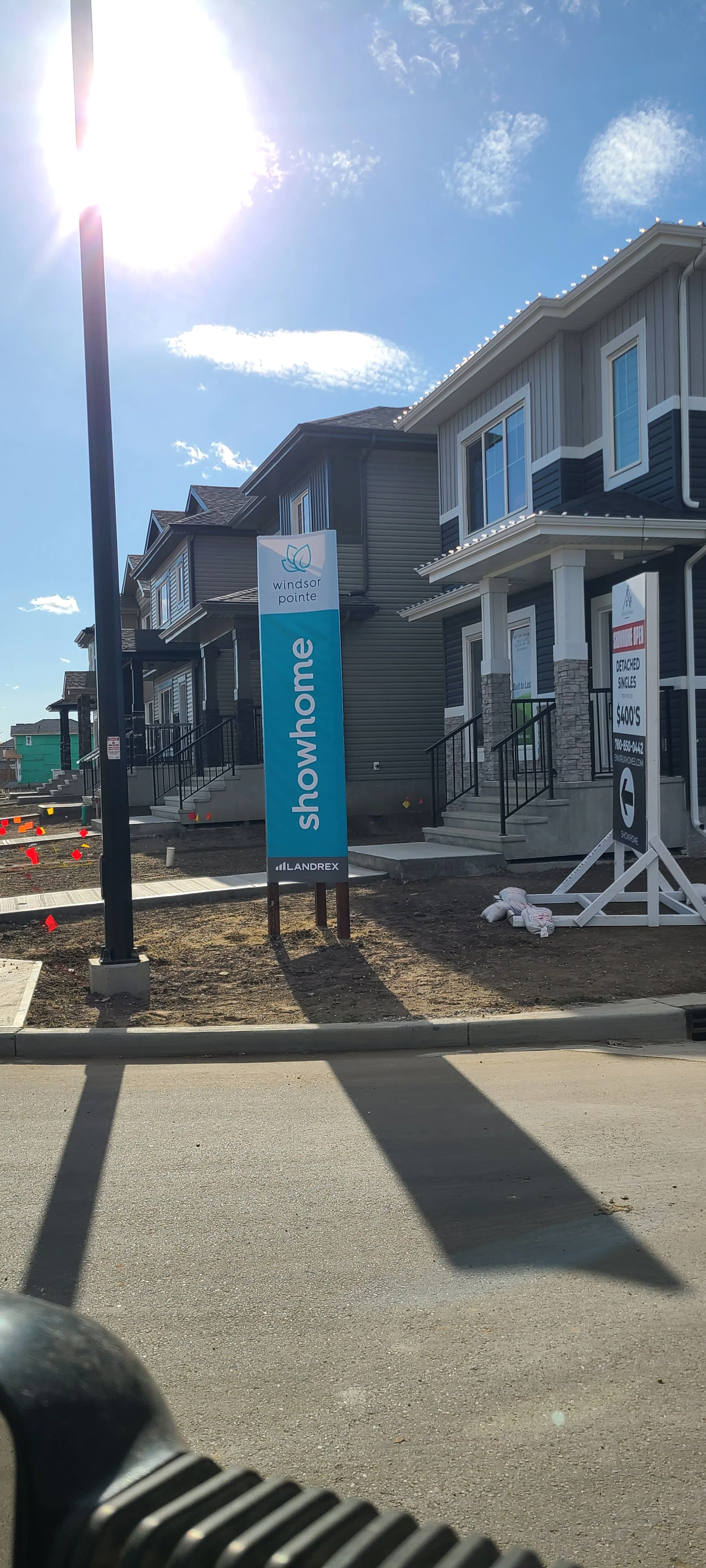 Newly constructed row of modern houses under construction with signs for Windsor Pointe development.