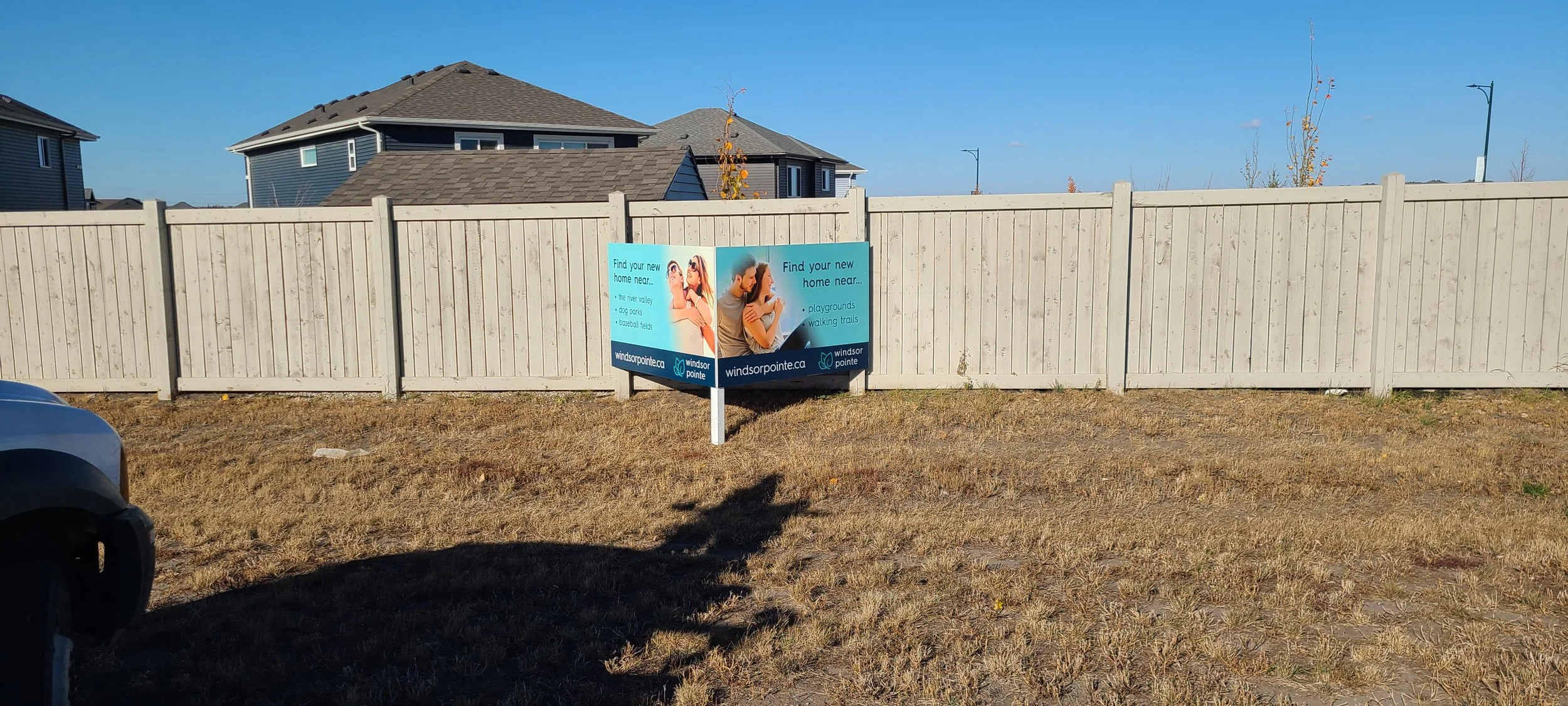 A sign advertising homes near parks, playgrounds, and trails.