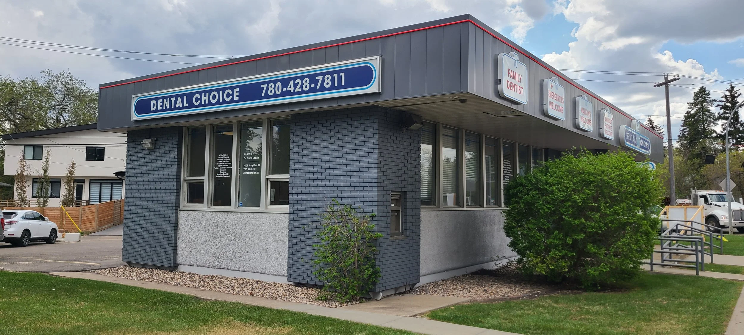 Exterior view of a dental clinic named Dental Choice with a blue sign displaying the phone number.