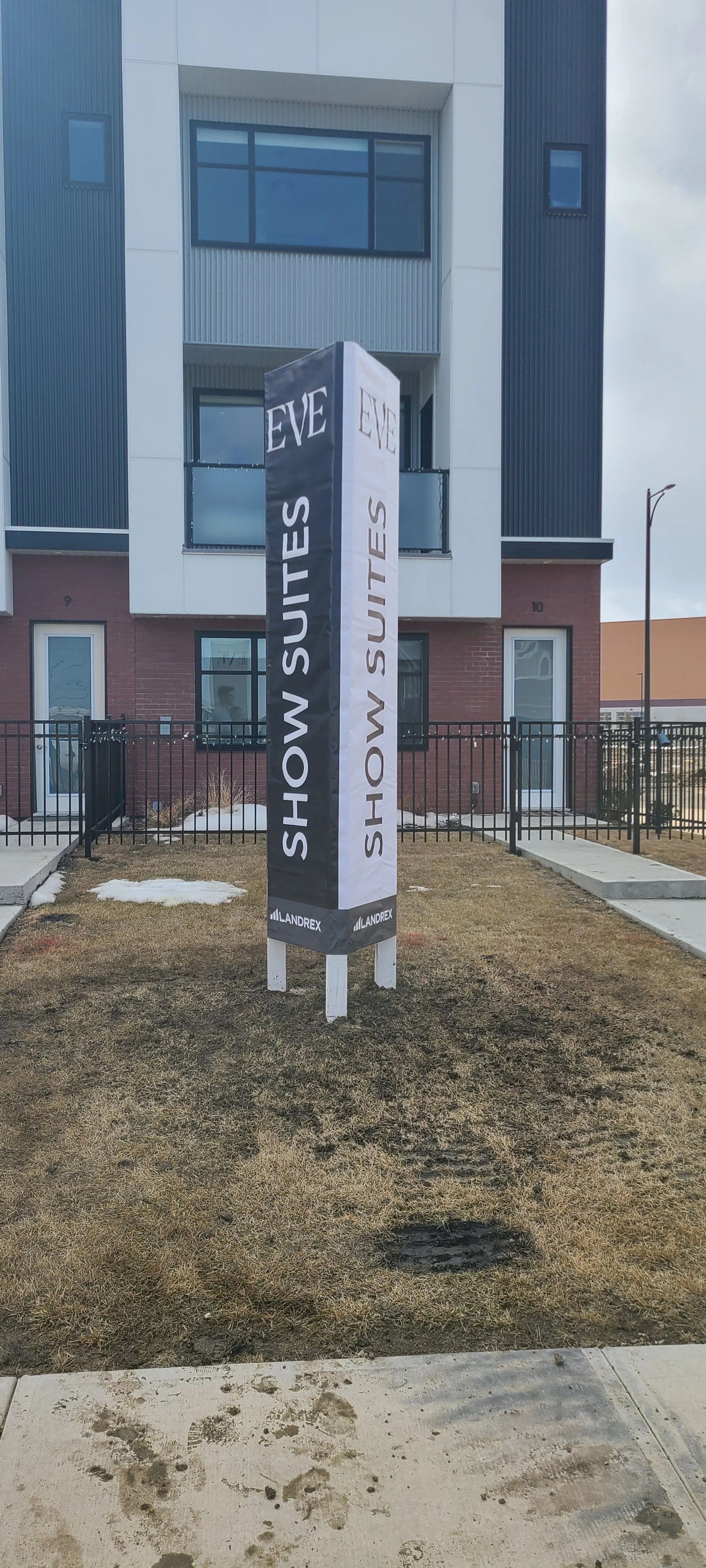 Sign for EVE Show Suites outside a modern .building. 