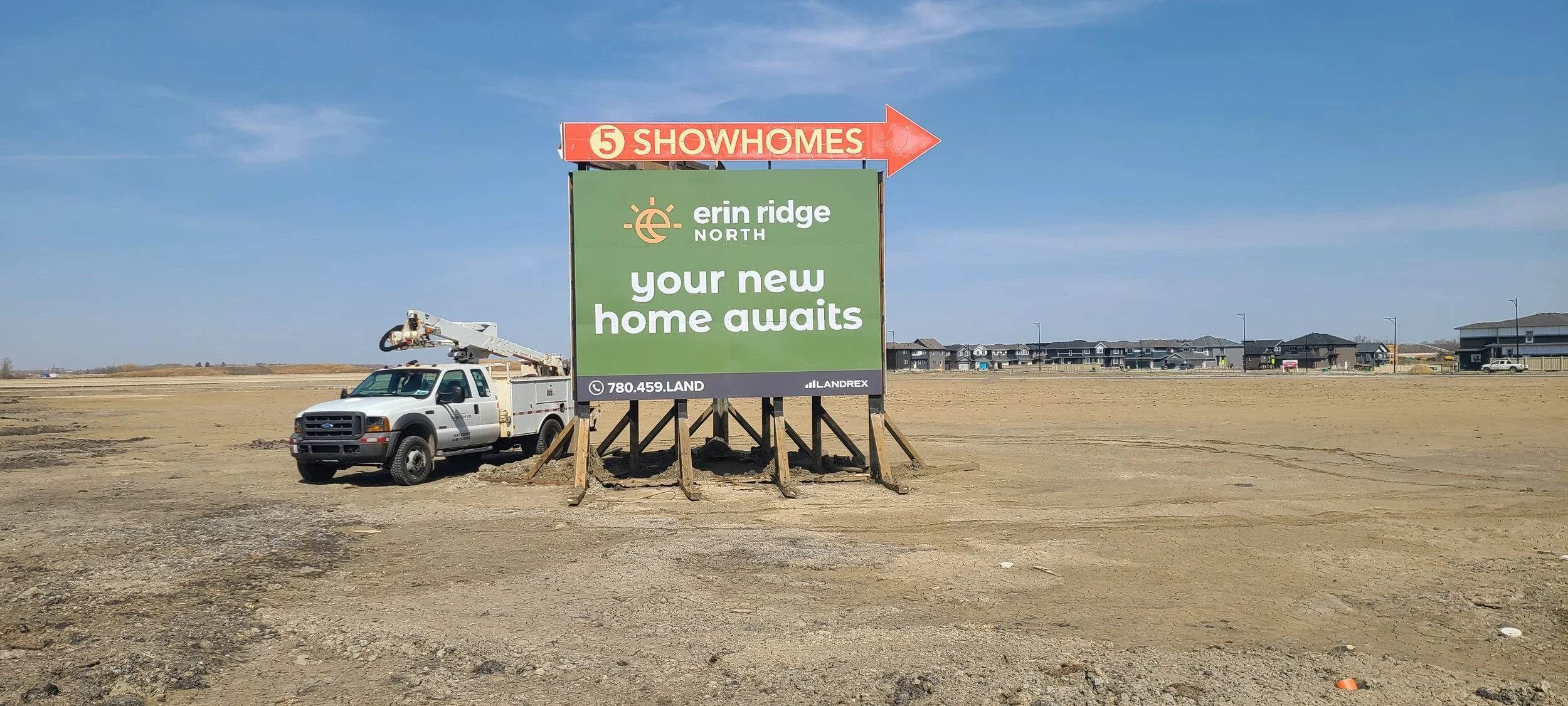 A large billboard advertising Erin Ridge North homes with the message 'your new home awaits'. 