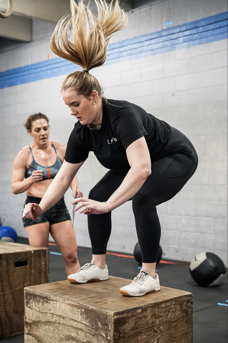 CrossFit Wash Park athlete doing box jumps during a workout