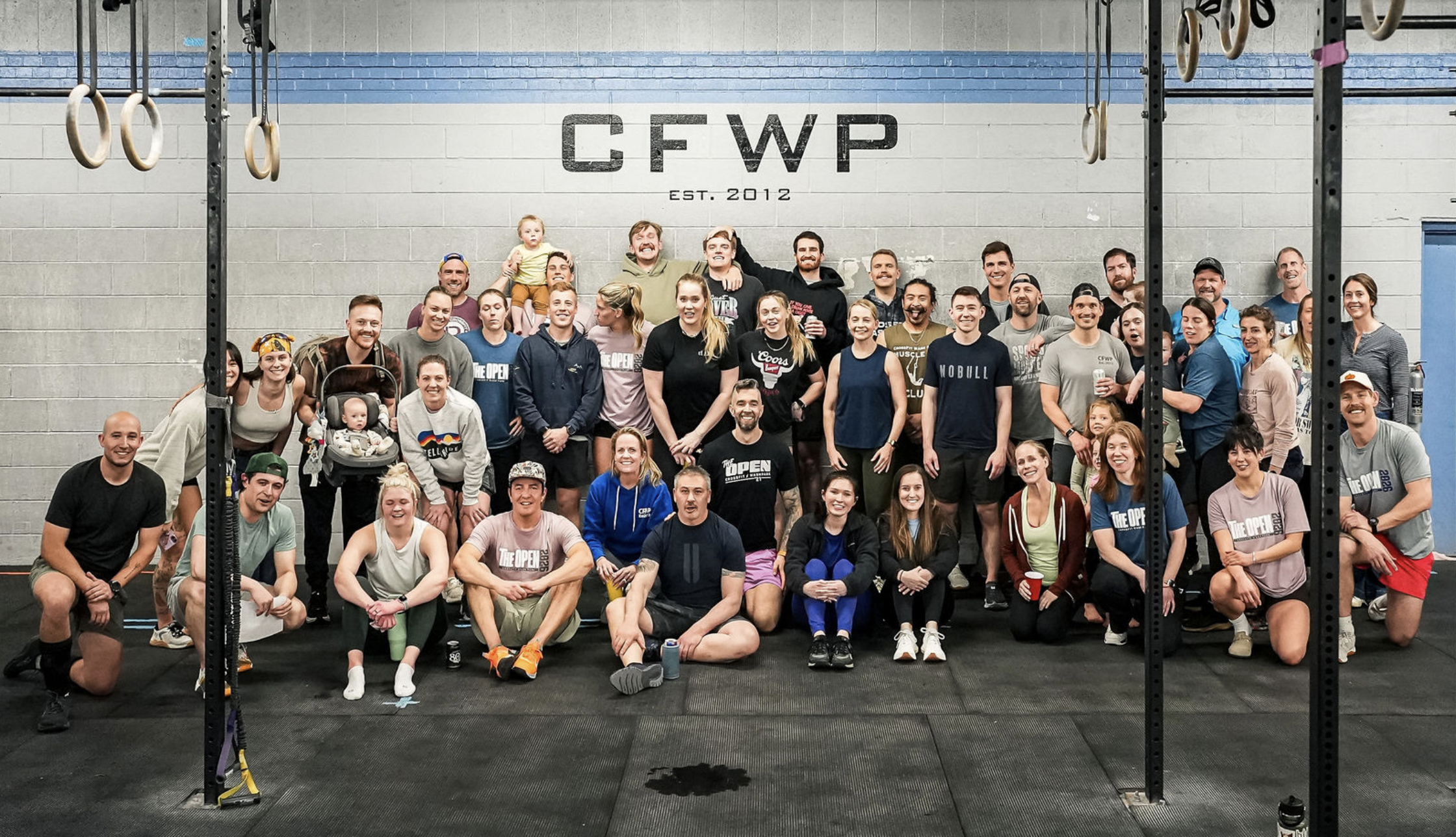 CrossFit Wash Park members and coaches gathered for a group photo at the gym in Denver