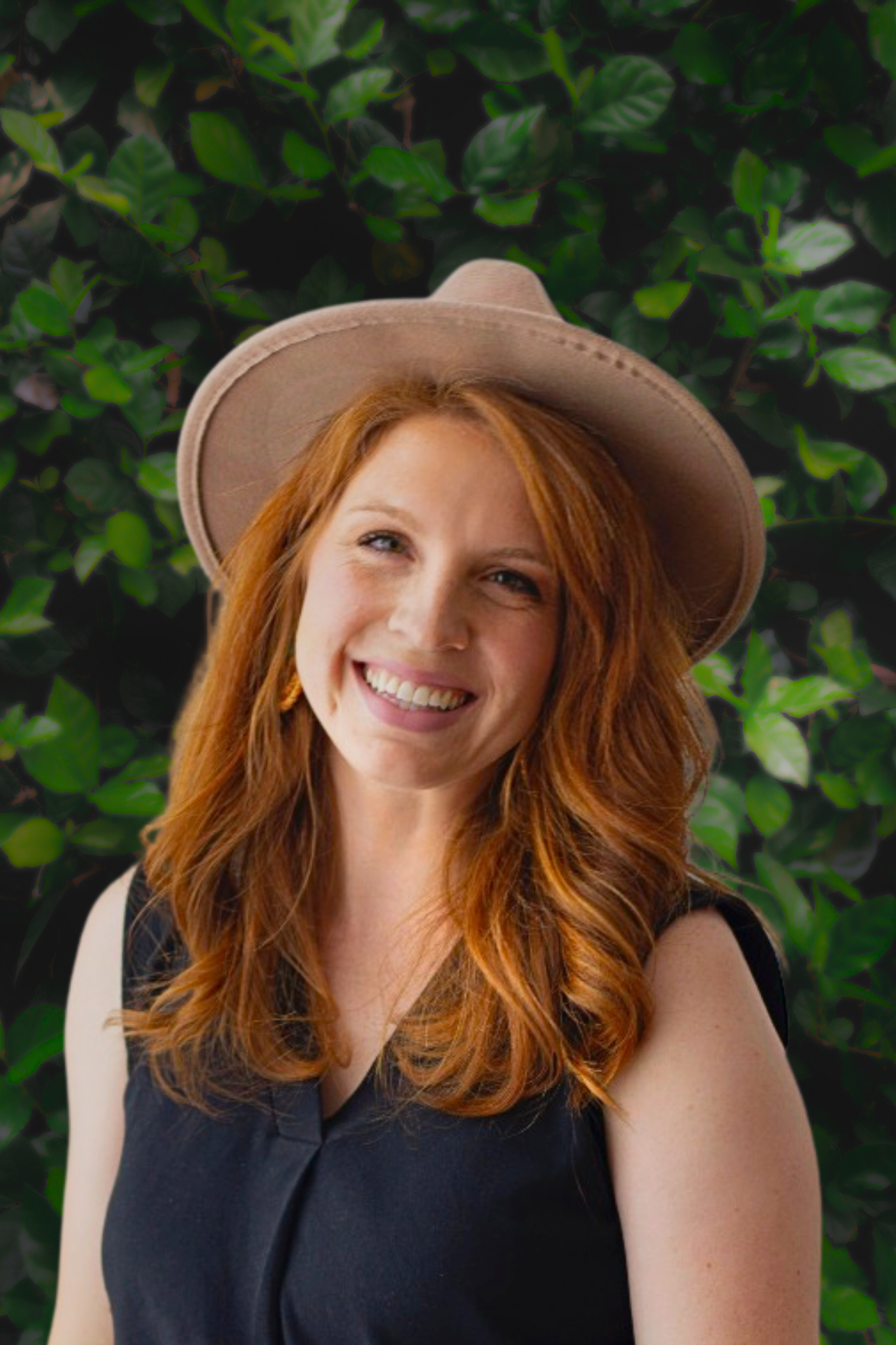 A young woman with red hair smiling and wearing a beige hat and a black sleeveless top, standing in front of green leafy bushes. Malana Bracht Arise Church Oklahoma City best pentecostal churches in Oklahoma city family centered spirit filled prophet