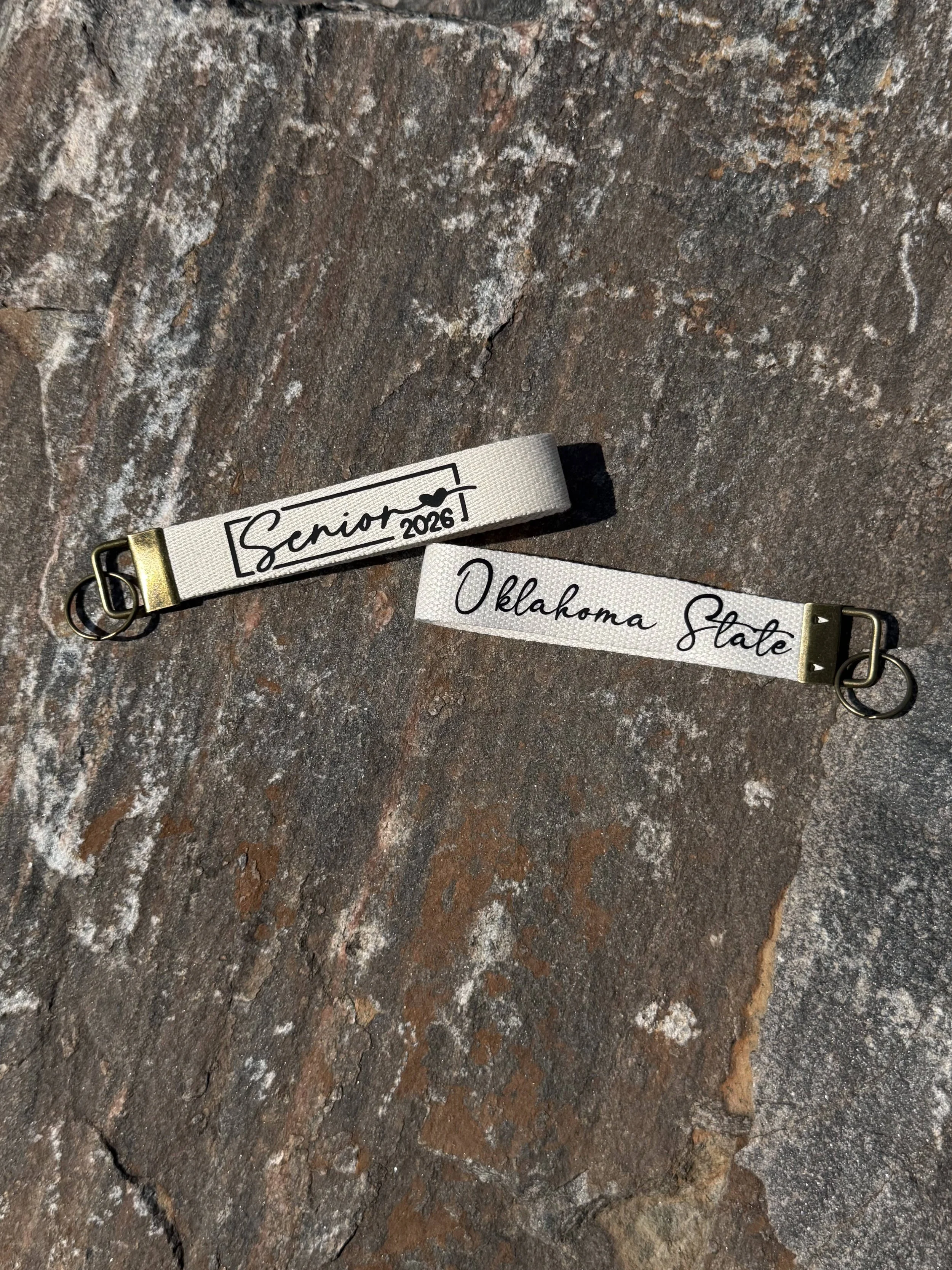 Senior_2026_Wristlet_Rock_Mockup_Cream.jpg