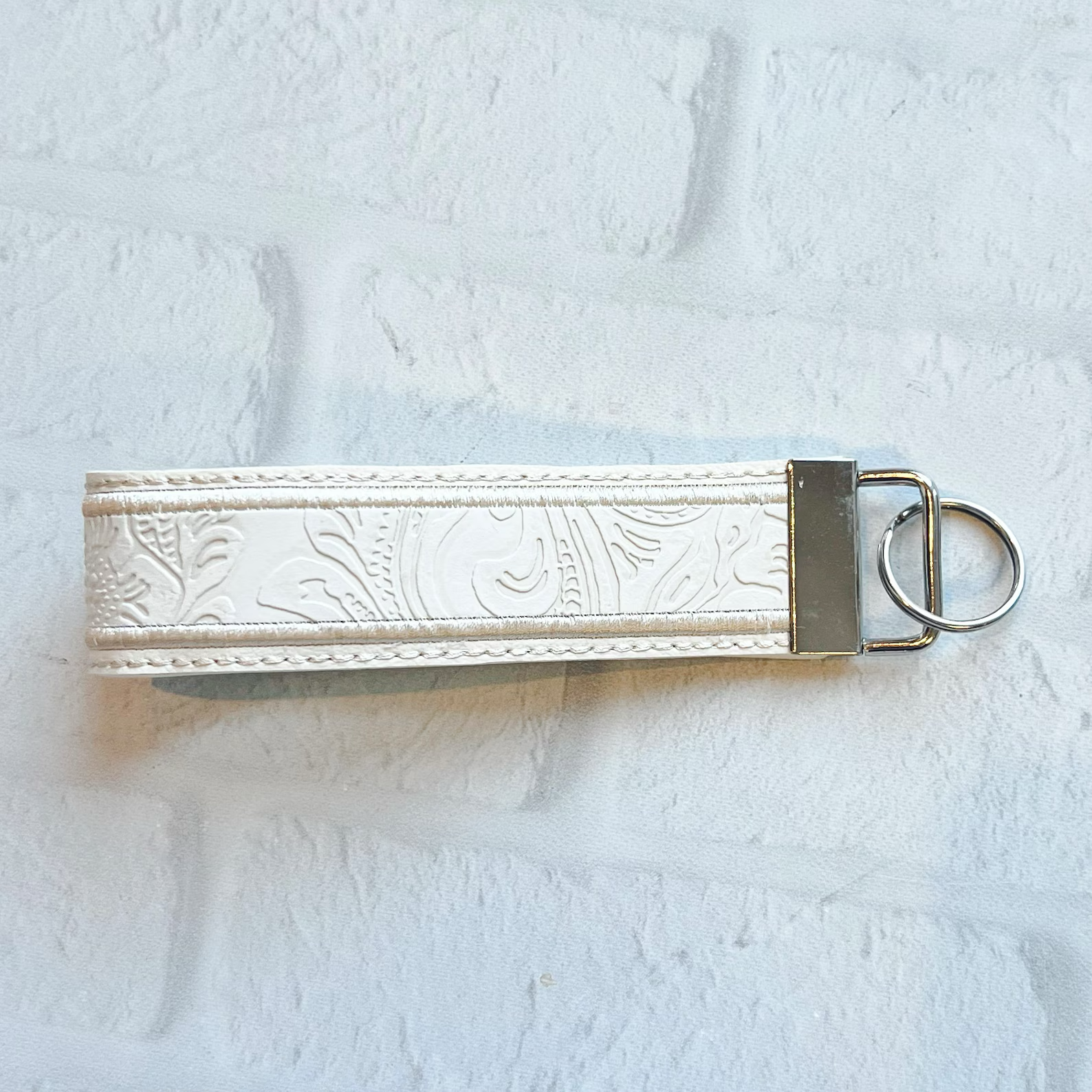 CREAM EMBOSSED WRISTLET KEYCHAIN