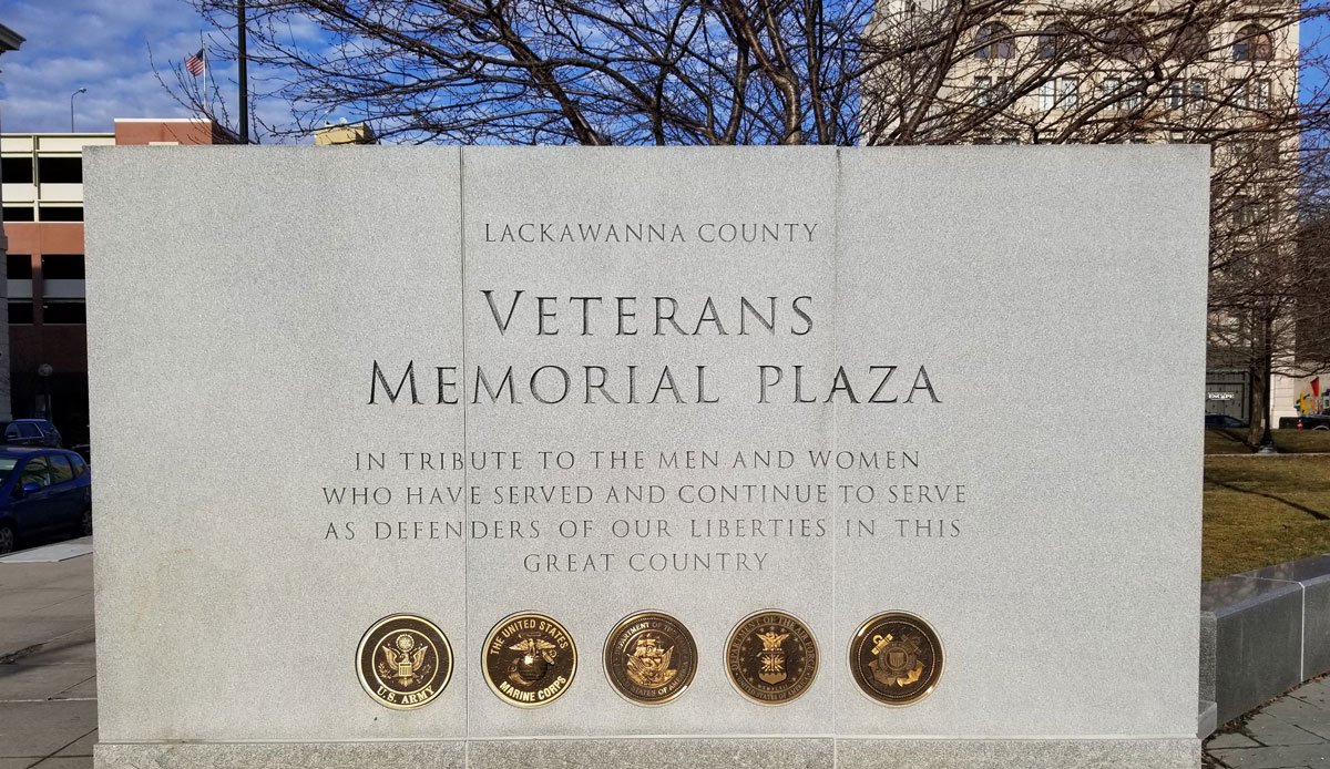 Veterans Memorial Plaza sign in Lackawanna County with seals of U.S. Army, U.S. Marine Corps, U.S. Navy, U.S. Coast Guard, and U.S. Air Force.