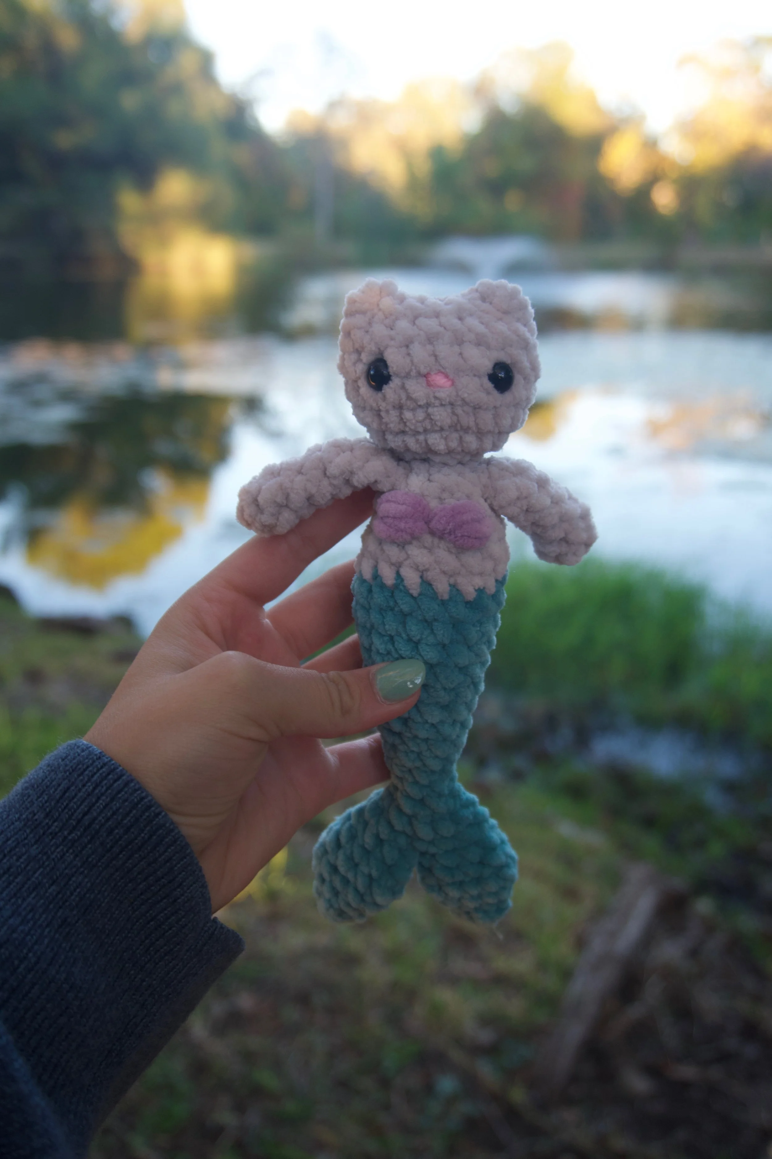 cat mermaid in front of water.jpeg