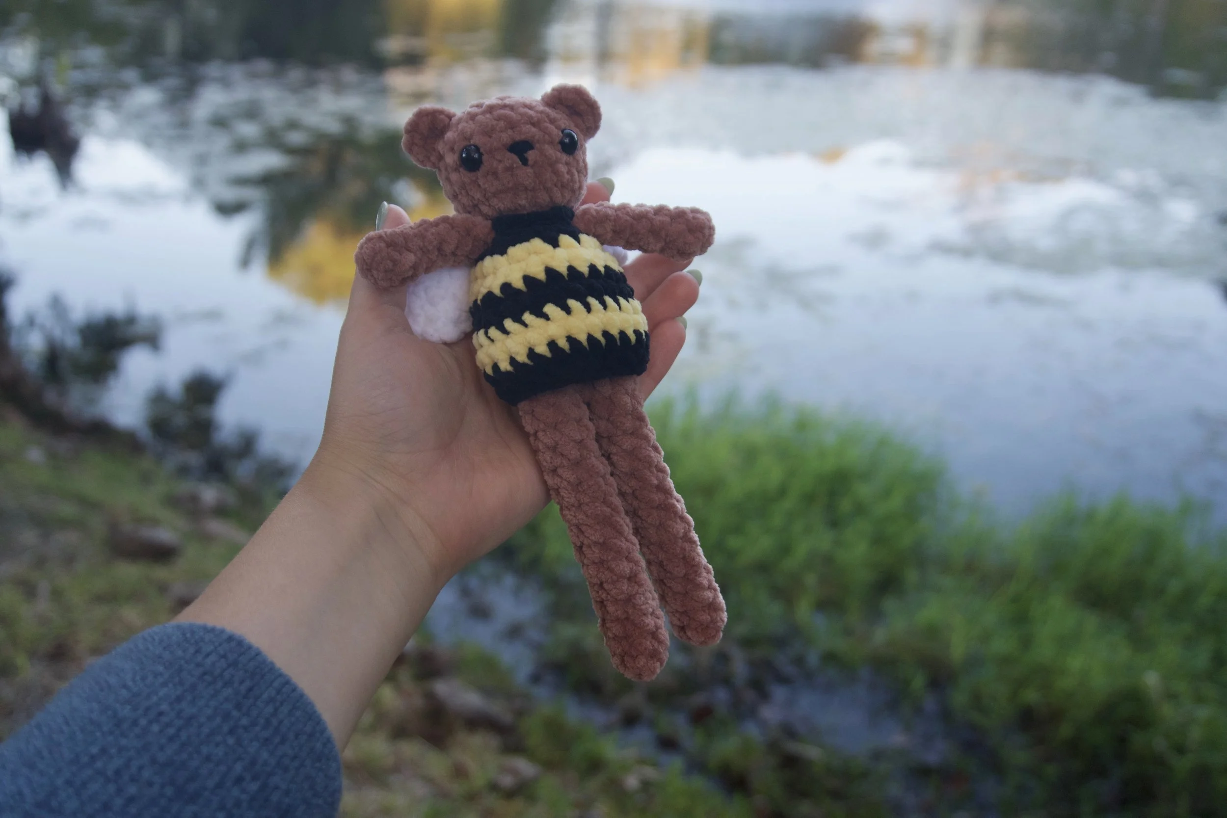 ted the teddy bear laying down on hand.jpeg