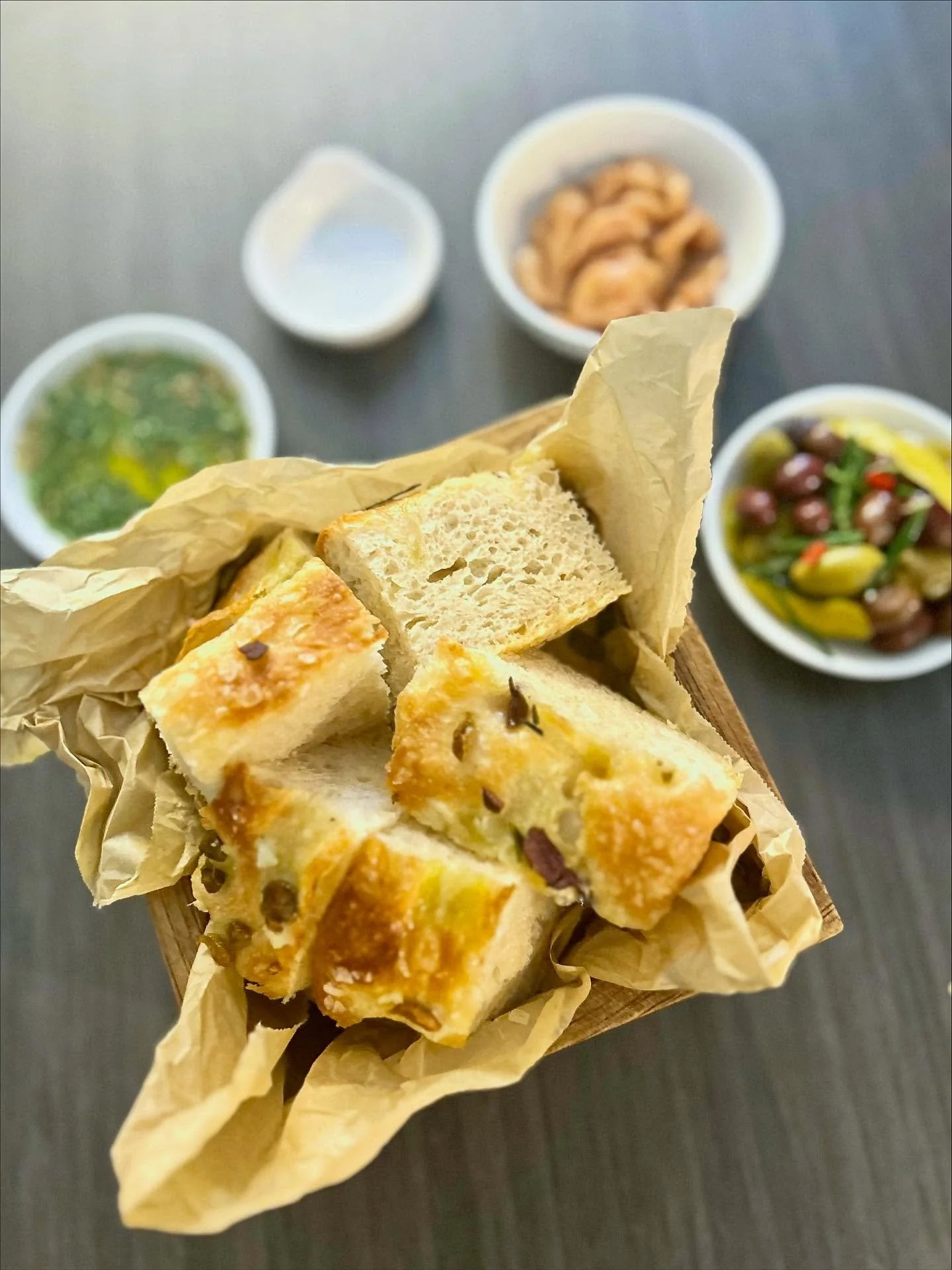 Start your service by adding our freshly baked focaccia bread service- Homemade olive and rosemary focaccia, confit garlic, marinated olives with garlic, chilli, rosemary, and lemon, and an infused olive oil with oregano and parsley.🫒🧄🌶️🌿