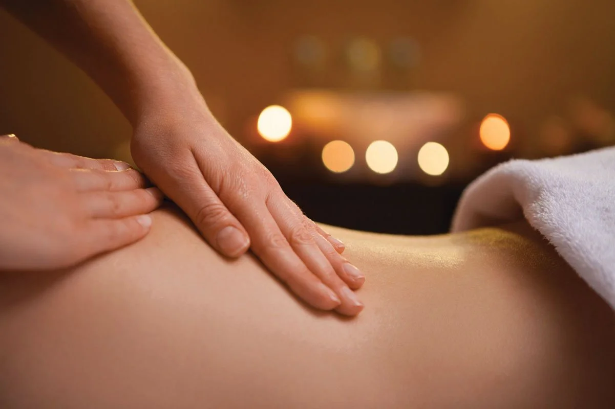 Close-up of a person receiving a massage on their back in a spa or massage setting.