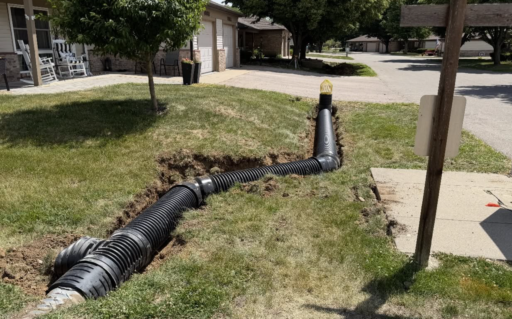 Storm drainage pipe installation underway to improve residential water runoff and drainage by OPS Outdoor Property Services.
