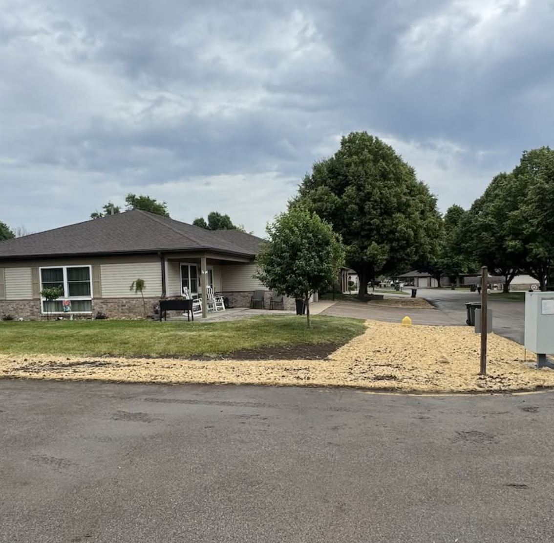 Completed residential drainage project with restored lawn, decorative stone, and improved stormwater management.