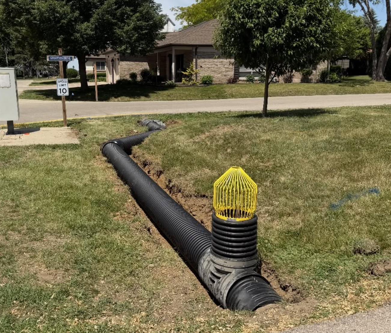 Underground drainage pipe system installed to redirect stormwater and protect residential property from water damage.