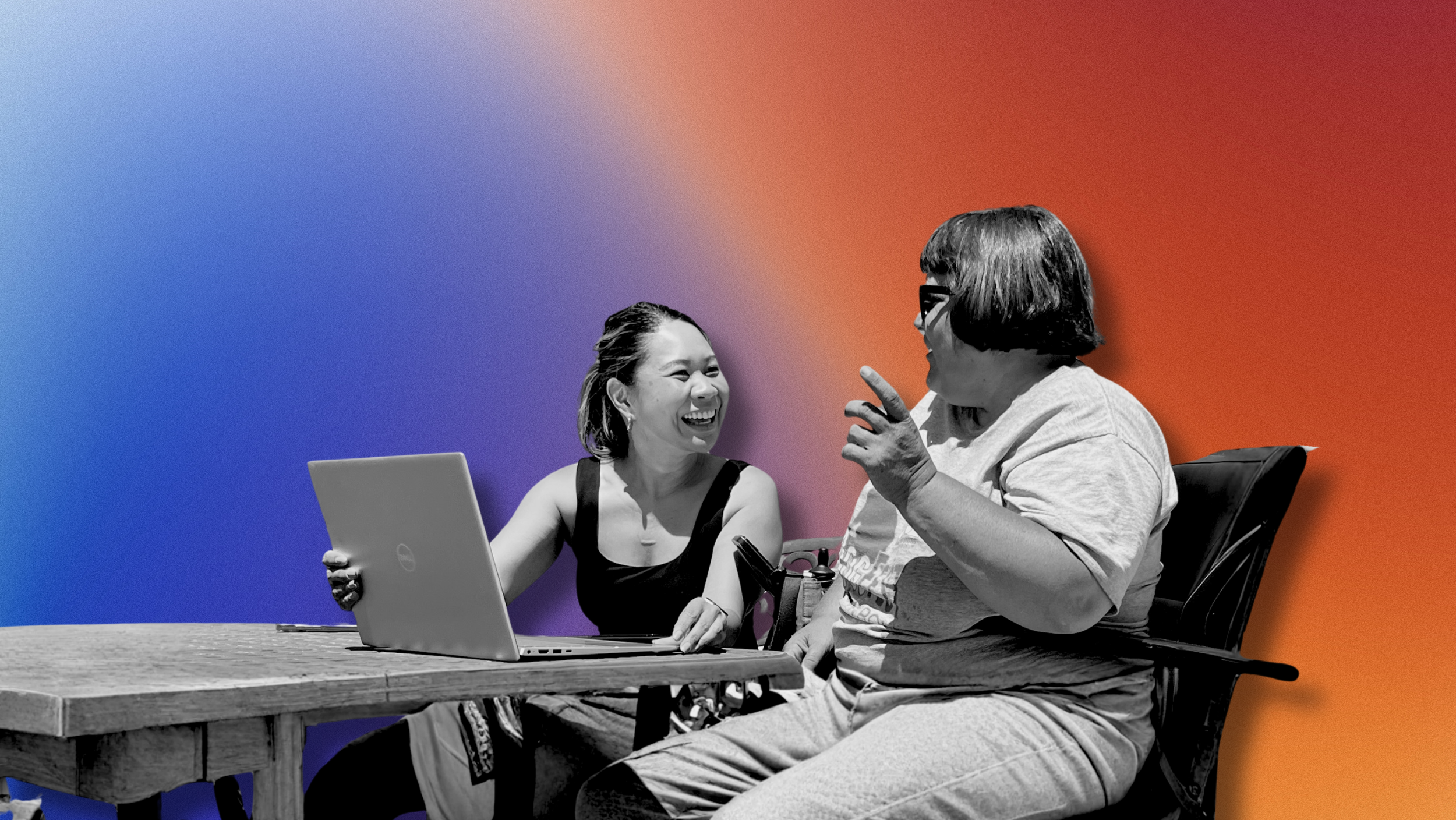 Two women engaged in a lively conversation, one holding a laptop, with a multicolored gradient background.