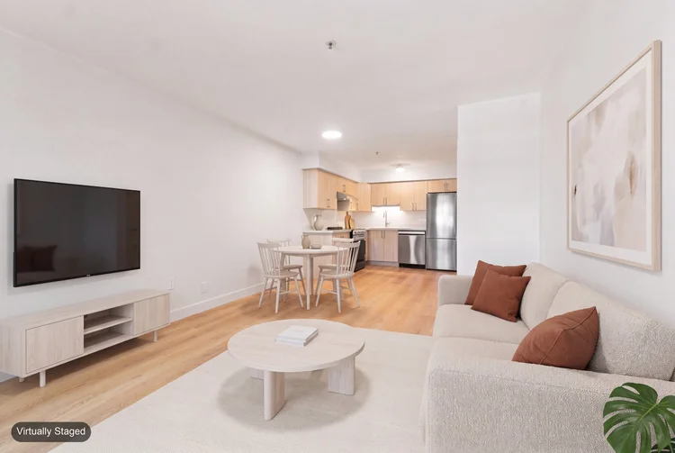 Staged living and dining area in unit 301 at 2928 Commercial Drive, Vancouver