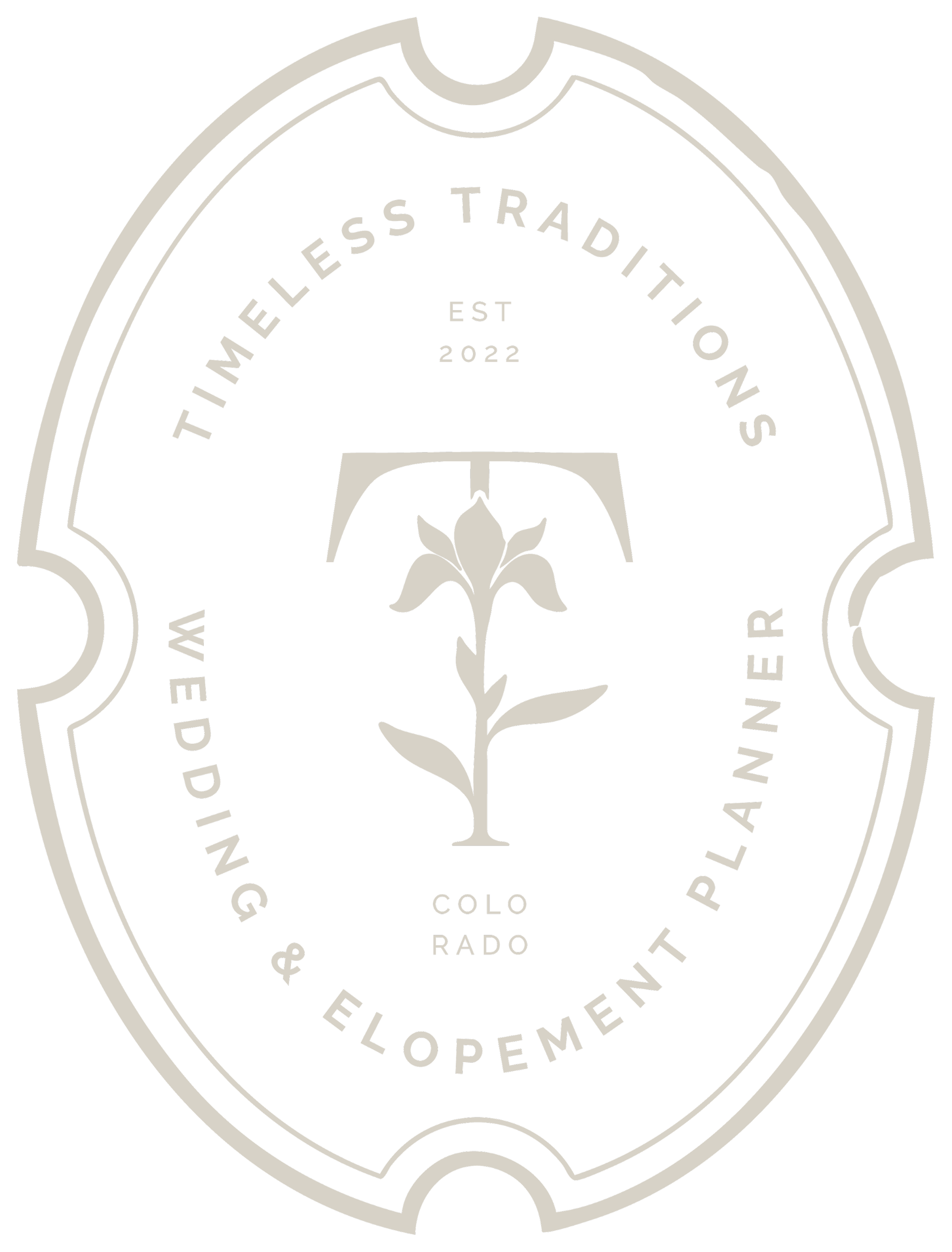 Black and white logo with an oval shape, featuring a flower in the center and text reading: 'Timeless Traditions, Wedding & Elopement Planner in Western Colorado'