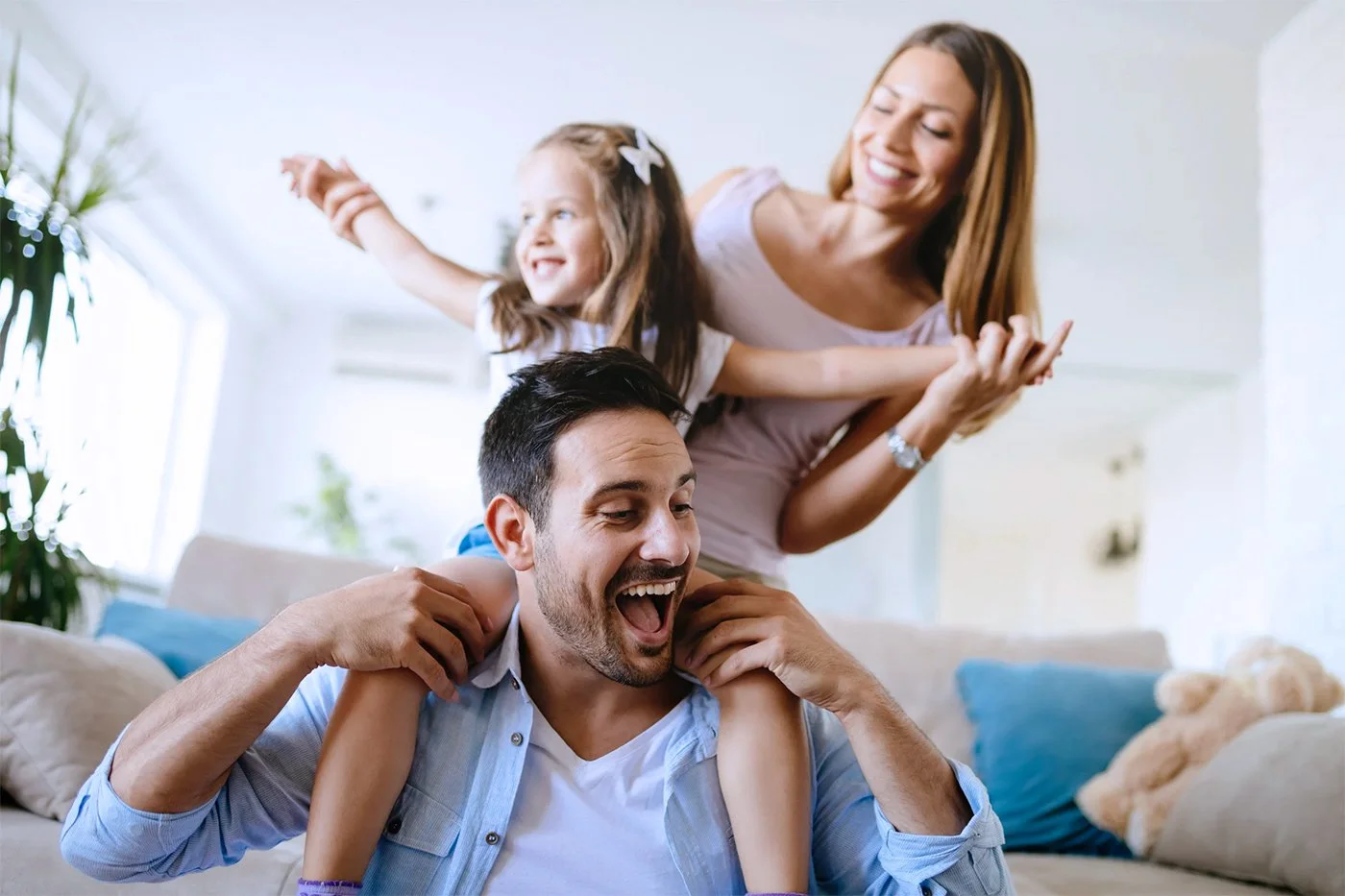 Redding family in living room covered by home insurance and life insurance