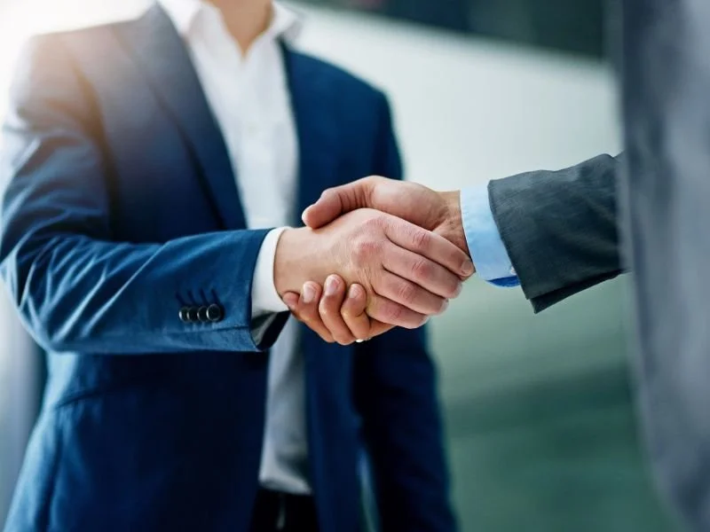 business men shaking hands after doing a business insurance deal with Kyle Vowell