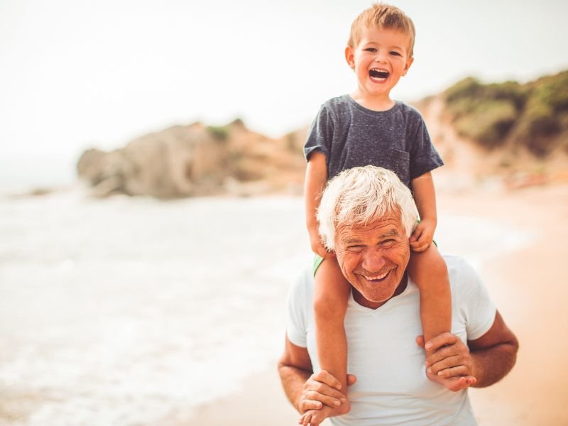 grandpa with index universal life insurance playing with his grandson
