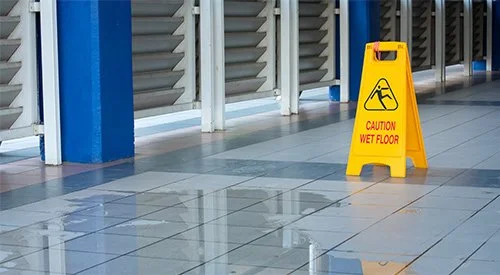 Wet floor sign in business covered by business insurance in Redding, CA